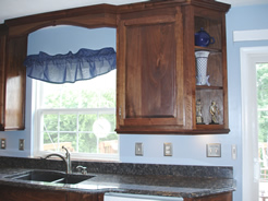 Angled corner cabinet with open shelves